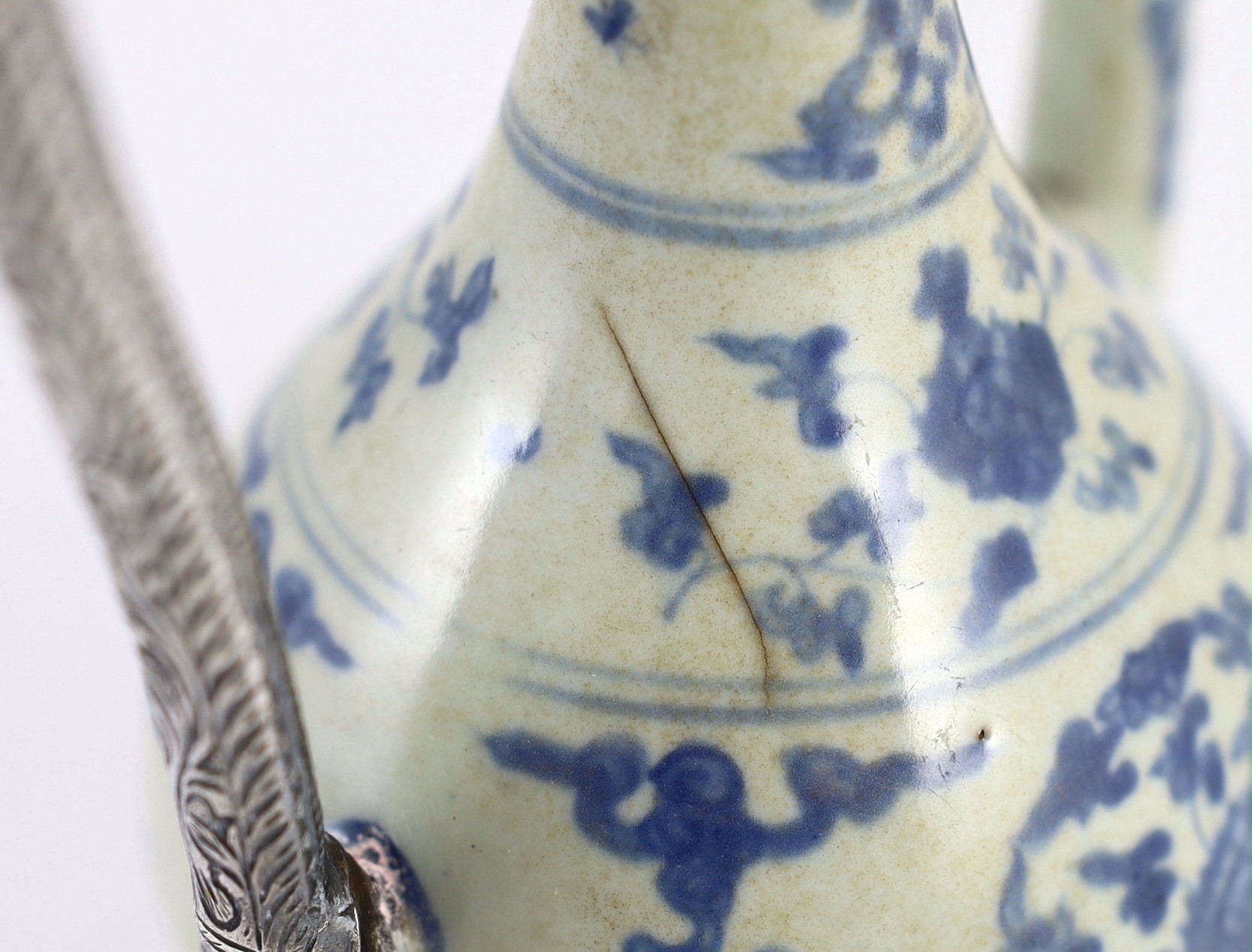 A Chinese late Ming blue and white ewer, made for the Islamic market, Jiajing to Wanli period, 21cm high, damage and later Islamic silver mounts